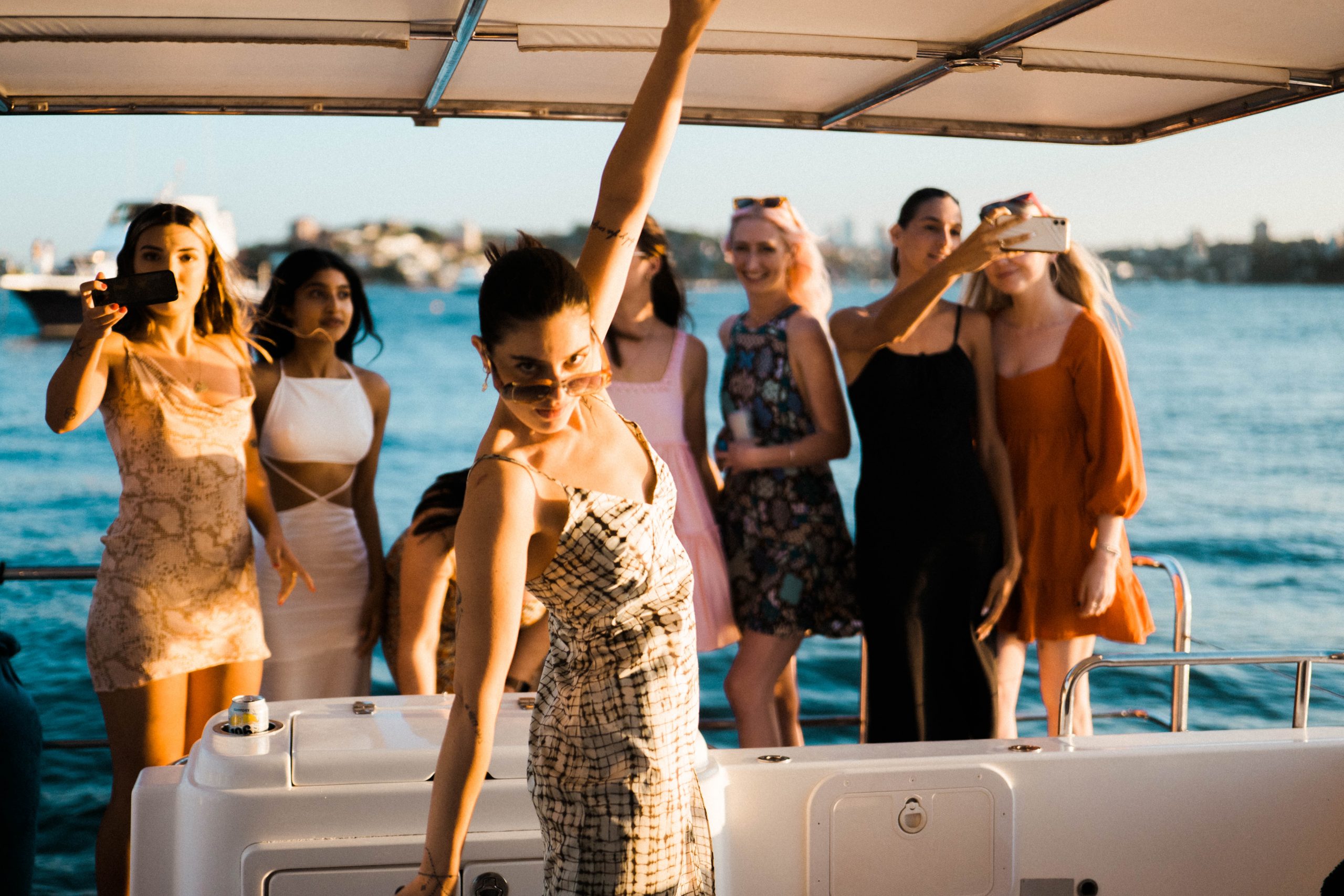 Friends celebrating aboard Life's Good at sunset
